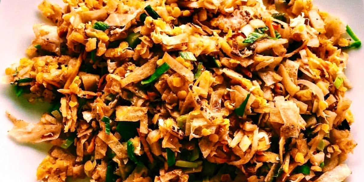 Kottu roti being prepared on a hot griddle at a street food stall in Sri Lanka