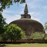 Ancient Rankoth Vehera stupa at Polonnaruwa UNESCO World Heritage Site Sri Lanka with visitors and tropical trees